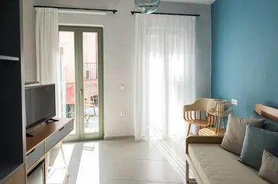 a living room with a couch and a tv at The48suites in Chania Town