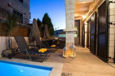 a patio with two chairs and a swimming pool at Villa Christy in Stalos