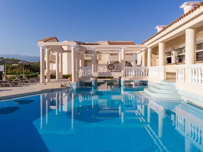 a house with a swimming pool in front of it at Hotel Caretta Beach in Gerani Chanion