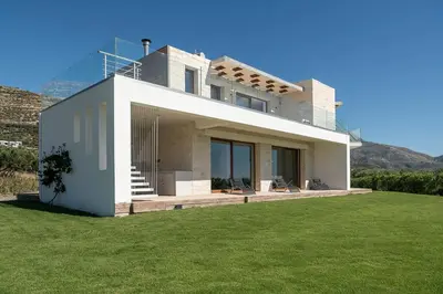 a house with a green lawn in front of it at Casa le Cicale in Falasarna