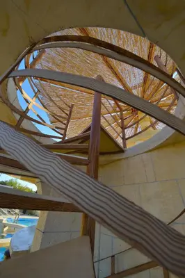 a spiral staircase in a building with a roof at Anemomili Village in Kissamos