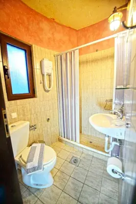 a bathroom with a toilet and a sink at Anemomili Village in Kissamos