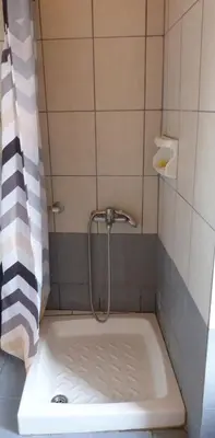 a bathroom with a shower with a bath tub at Kydonia Rooms in Chania Town
