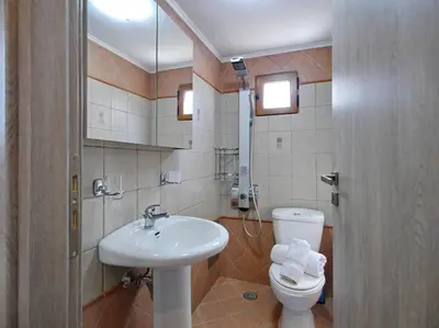 a bathroom with a toilet and a sink at Villa Vangelis Stylos Crete in Khiliomoudhoú