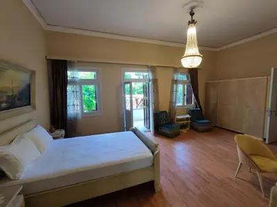 a bedroom with a bed and a chandelier at Gardens Downtown center Chania Elpida Villa in Chania Town
