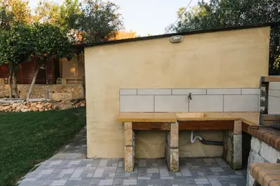 a wooden table against a wall with a bench at Wooden Beach House in Gerani Chanion