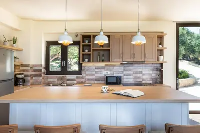 a kitchen with a large island in the middle at Villa Kudos in Maleme