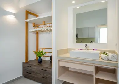a bathroom with a sink and a mirror at Lotus Hotel Apartments in Kato Daratso