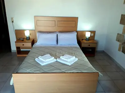 a bedroom with a bed with two towels on it at Traditional House Koukounara in Kissamos