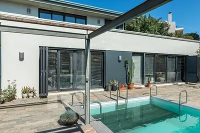 a swimming pool in front of a house at Artistic Pool Private Villa in Chania Town