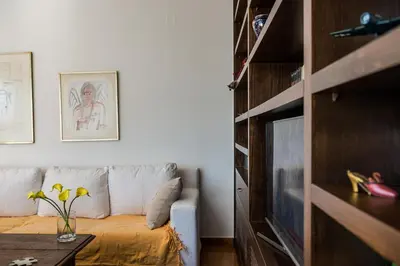 a living room with a couch and a tv at Artistic Pool Private Villa in Chania Town