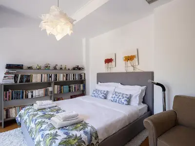 a bedroom with a bed with a book shelf at Artistic Pool Private Villa in Chania Town
