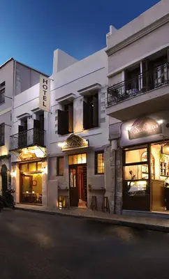 a white building with some tables in front of it at Odos Oneiron Boutique Hotel in Chania Town