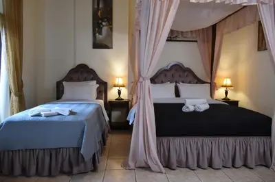 a bedroom with two beds and two lamps at Odos Oneiron Boutique Hotel in Chania Town