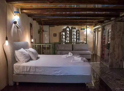 a bedroom with a bed and a couch in a room at Odos Oneiron Boutique Hotel in Chania Town