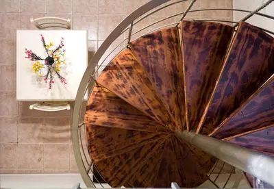 a spiral staircase in a bathroom with a painting on the wall at Odos Oneiron Boutique Hotel in Chania Town