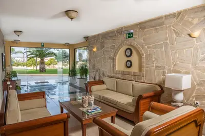 a living room with a stone wall at Mirtilos Studios & Apartments in Kissamos
