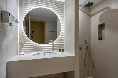 a bathroom with a sink and a mirror at Mirtilos Studios & Apartments in Kissamos