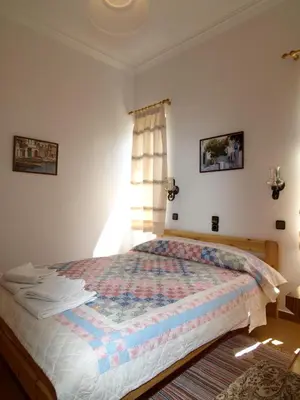 a bedroom with a bed with a quilt on it at Villas Michalis in Chorafakia