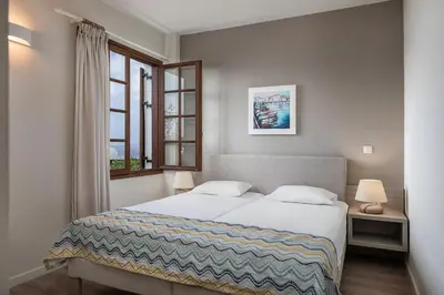 a bedroom with a bed and a window at Alianthos Suites in Tersanas