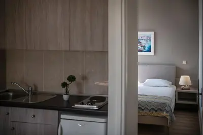 a hotel room with a bed and a sink at Alianthos Suites in Tersanas