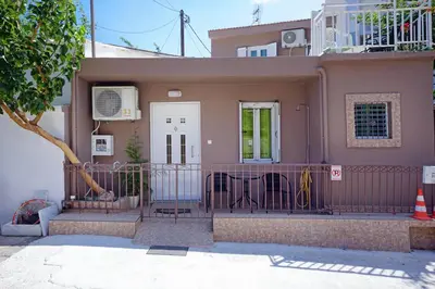 a pink house with a fence in front of it at Nea Chora Maisonette in Chania Town