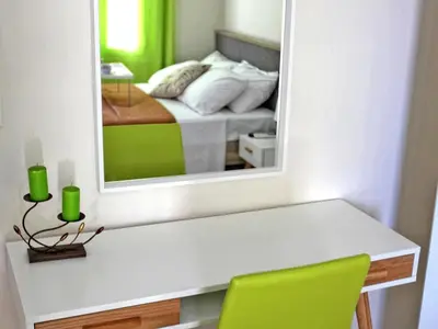 a mirror over a table with a bed in a bedroom at Nea Chora Maisonette in Chania Town