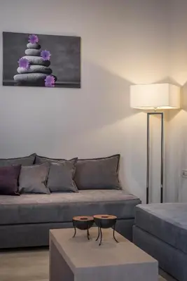 a living room with a couch and a table at Trianon Luxury Apartments & Suites in Chania Town