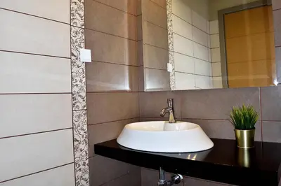 a bathroom with a sink and a mirror at The Well in Chorafakia