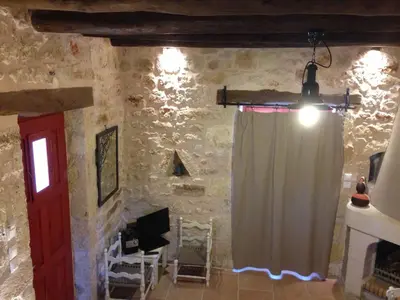 a room with a curtain and a stone wall at Fabrica in Vamos