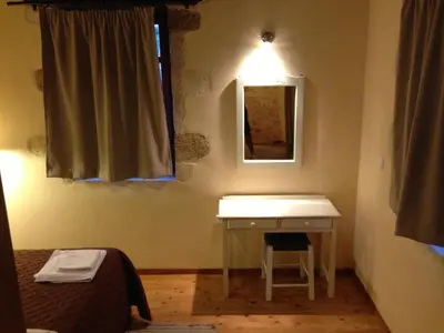 a bathroom with a sink and a mirror and a bed at Fabrica in Vamos