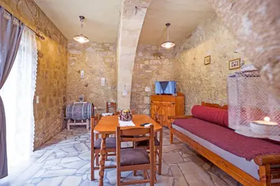 a living room with a couch and a table at Petrakis Cretan Homes in Kissamos