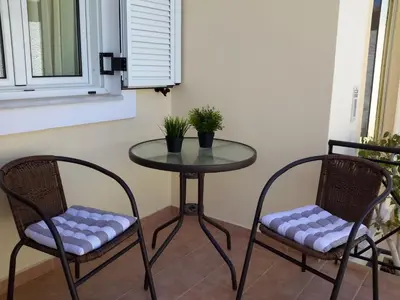 a table and two chairs with plants on it at Rena House in Kissamos