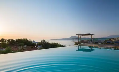 a swimming pool with a view of the water at Olea Prime in Marathi