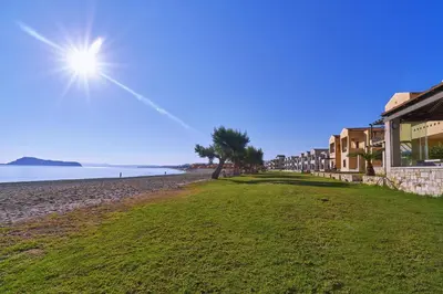 a view of a beach with buildings and trees at Silver Beach Hotel & Apartments in Gerani Chanion