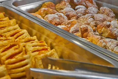 a display case of waffles and donuts in a bakery at Silver Beach Hotel & Apartments in Gerani Chanion