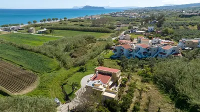 an aerial view of a house on a hill next to the ocean at Gea Maleme in Maleme