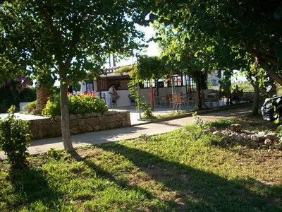 a park with trees and grass and a sidewalk at San Antonio Apartments in Kolymvari