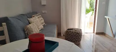 a living room with a couch and a table at Viena Rooms & Apartments in Palaiochóra