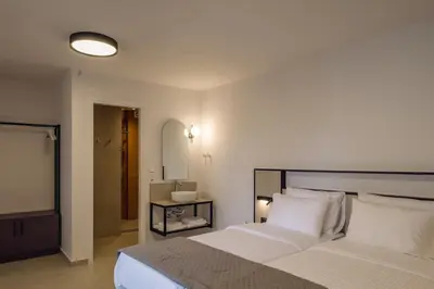 a bedroom with a large white bed with white pillows at Casa Veneta in Chania Town