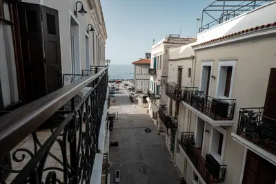 an alley with buildings and the ocean in the background at Casa Veneta in Chania Town