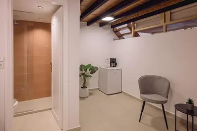 a hallway with a chair and a trash can at Casa Veneta in Chania Town
