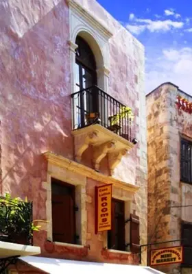 a building with a balcony with a dog on it at Caza Latina in Chania Town