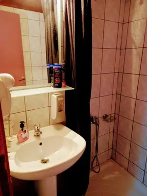 a bathroom with a sink and a shower at Caza Latina in Chania Town