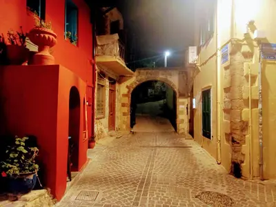 an empty alley with an archway in a building at Caza Latina in Chania Town