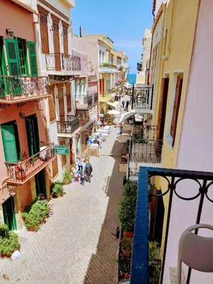 an overhead view of an alley with people sitting on tables at Caza Latina in Chania Town
