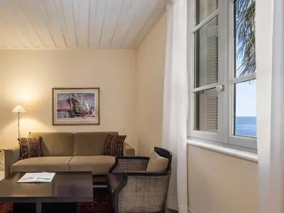 a living room with a couch and a table and a window at Villa Andromeda in Chania Town