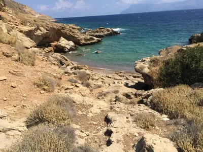a view of the ocean from a rocky beach at MmeBassia in Chania Town