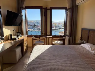 a hotel room with a bed and a view of a city at Helena Hotel in Chania Town