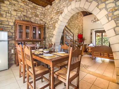 a kitchen and dining room with a wooden table and chairs at Falasarna Villas in Falasarna